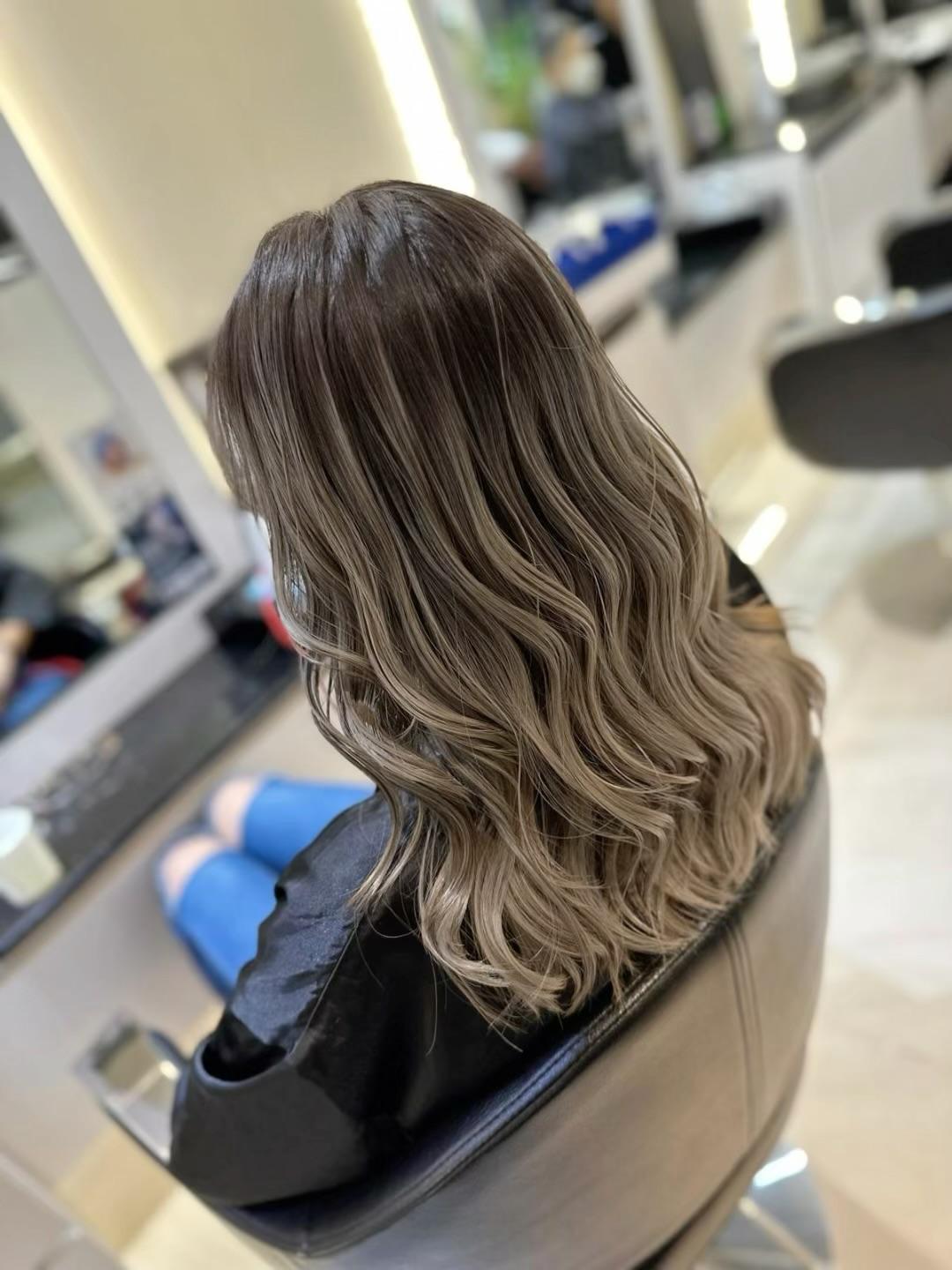 Warm brunette blowout with curtain fringe and airy volume